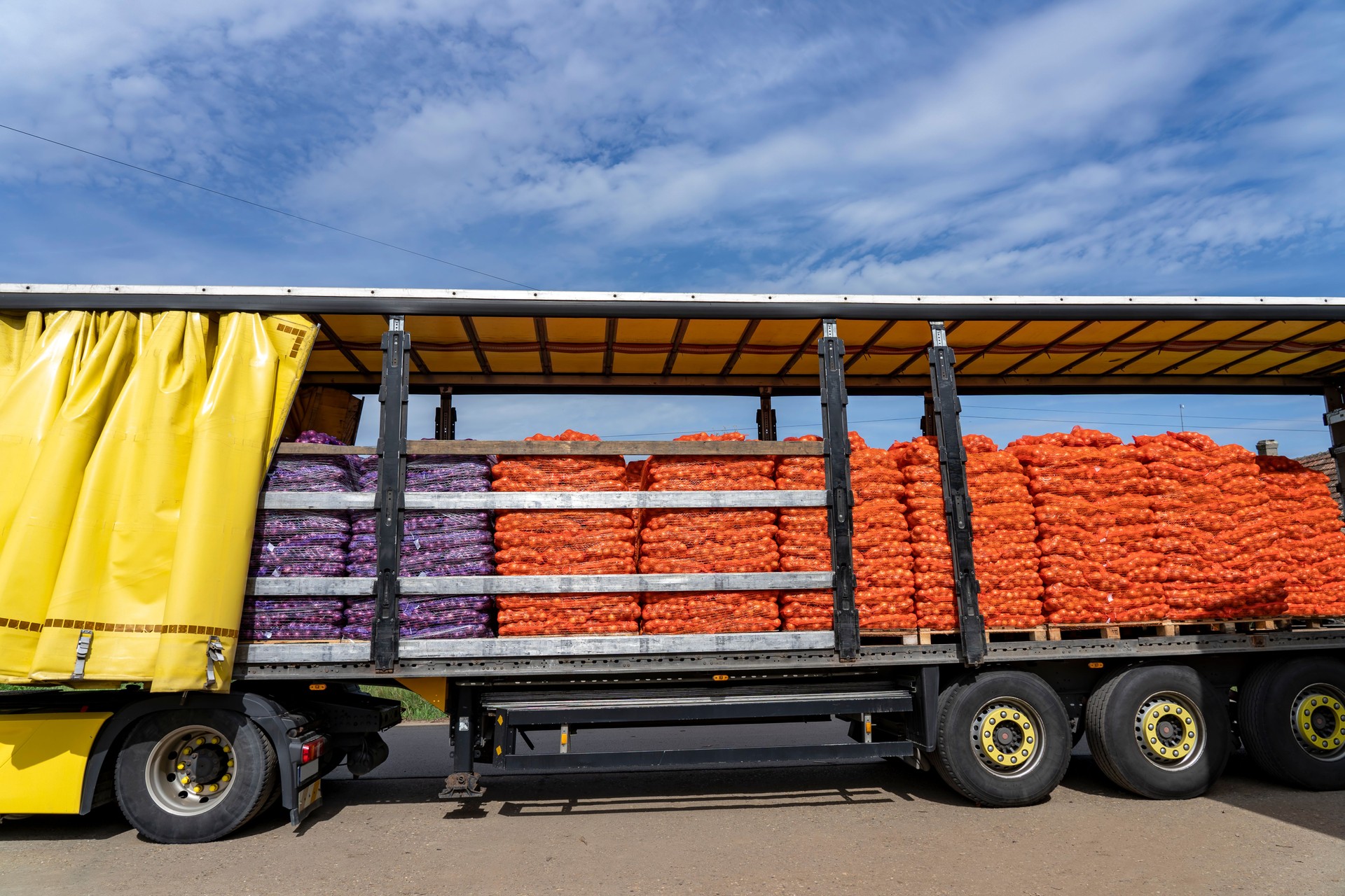 Loading Truck With Palletized Onion Bags Wrapped in Netting for Distribution to Market